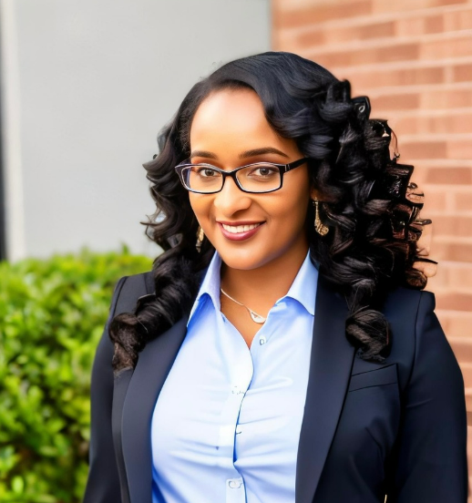 Shanique Bryant smiling, wearing a navy blazer and light blue shirt